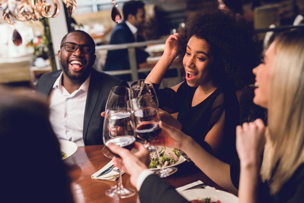 Group young people drinking wine at a restaurant - Miami Spice Restaurant Months